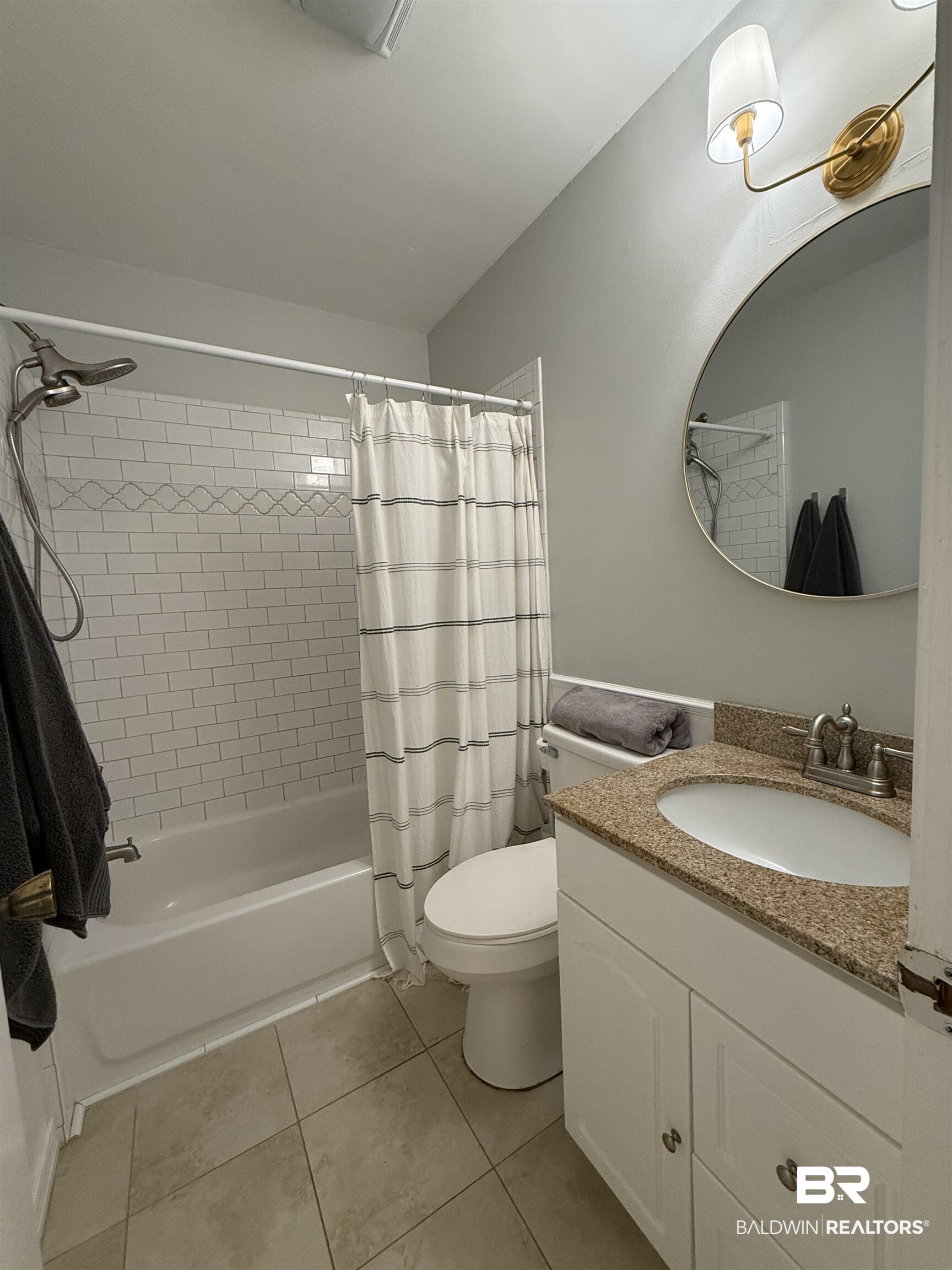 90 Florida Street Monroeville, AL 36460 - Photo 24 of 31 Full bathroom with vanity, toilet, shower / bath combo with shower curtain, and tile patterned flooring