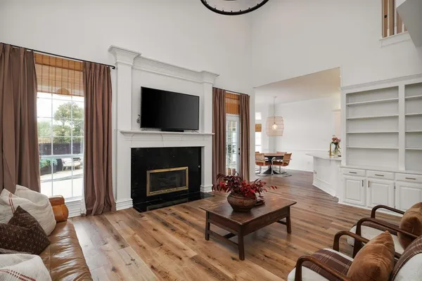 a living room with furniture fireplace and flat screen tv