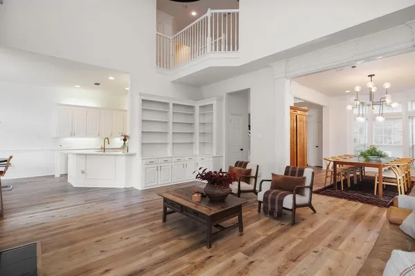 a living room with furniture and view of kitchen