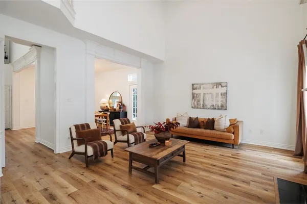 a living room with furniture and a wooden floor
