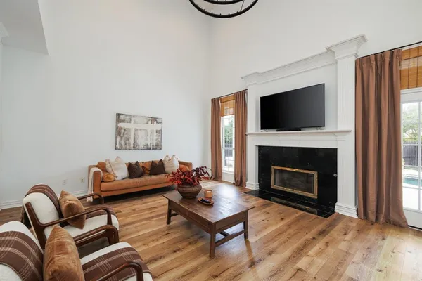 a living room with furniture a flat screen tv and a fireplace