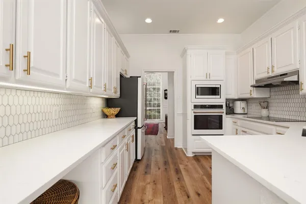 a kitchen with stainless steel appliances a stove refrigerator sink and cabinets