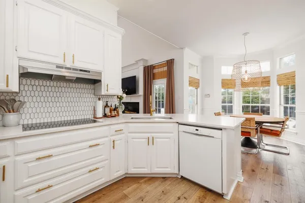 a kitchen with granite countertop white cabinets and white appliances