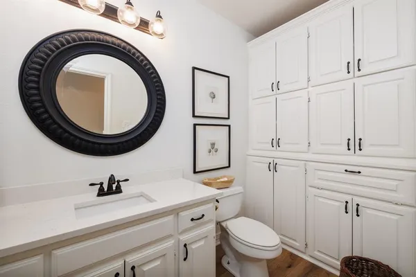 a bathroom with a sink a toilet and a mirror