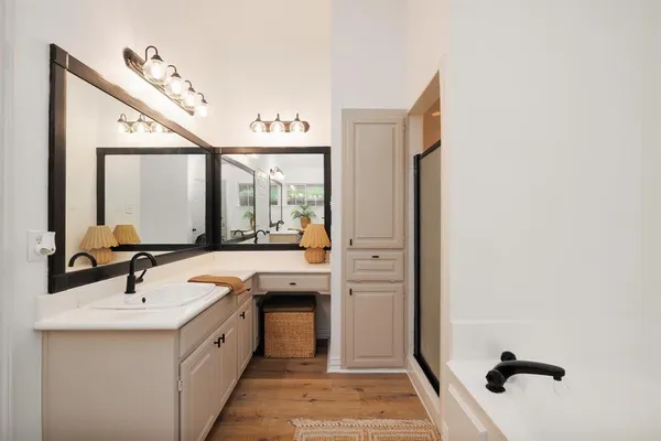 a spacious bathroom with a double vanity sink and mirror