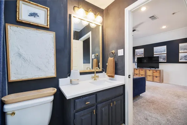 a bathroom with a sink a toilet and mirror