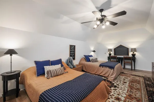 a bedroom with bed and a chandelier