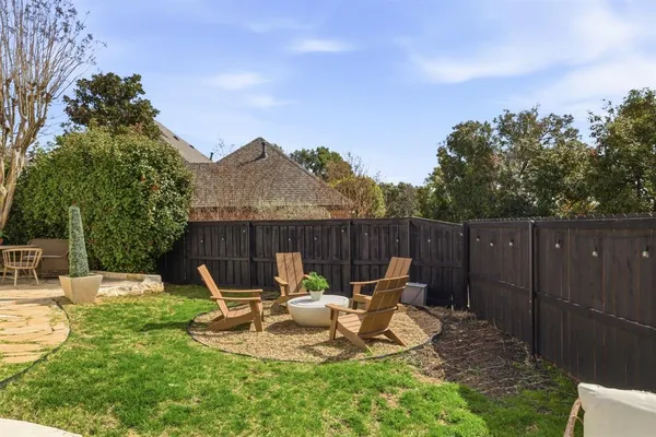 a view of a chair and table in backyard