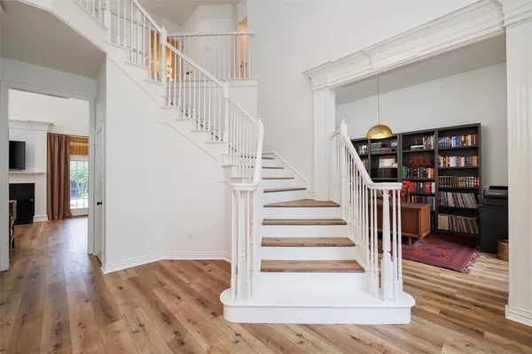 a view of entryway and hall with wooden floor