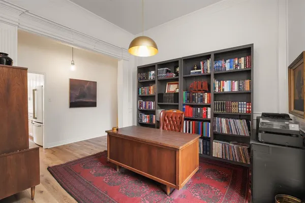 a living room with furniture and a book shelf