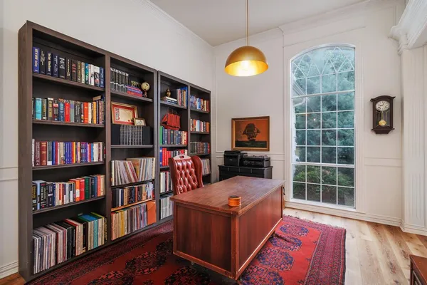 a living room with furniture and a book shelf