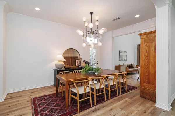 a view of a dining room with furniture and chandelier