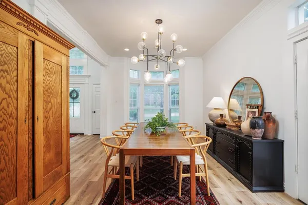 a view of a dining room with furniture and chandelier