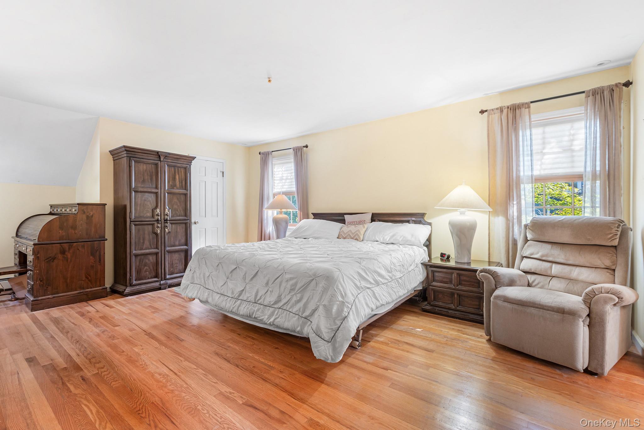 7 Byram Meadows Road Armonk, NY 10504 - Photo 22 of 32 a spacious bedroom with a bed and a couch