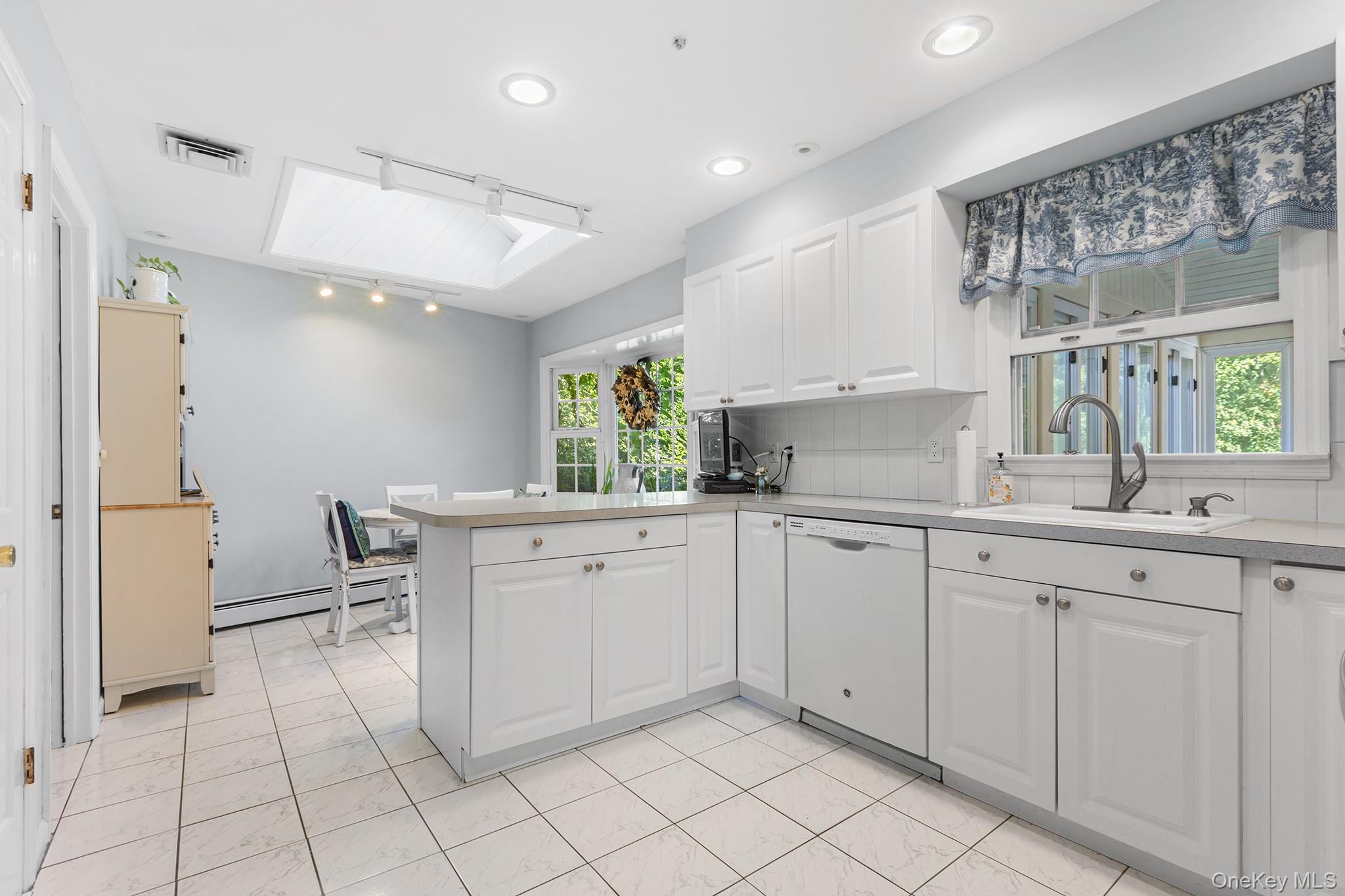 7 Byram Meadows Road Armonk, NY 10504 - Photo 8 of 32 a kitchen with white cabinets and sink