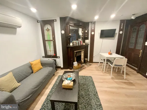 a living room with furniture and a fireplace