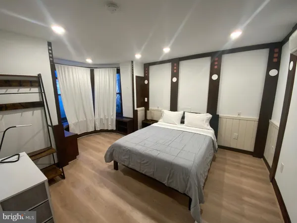 a bedroom with a bed and a large mirror