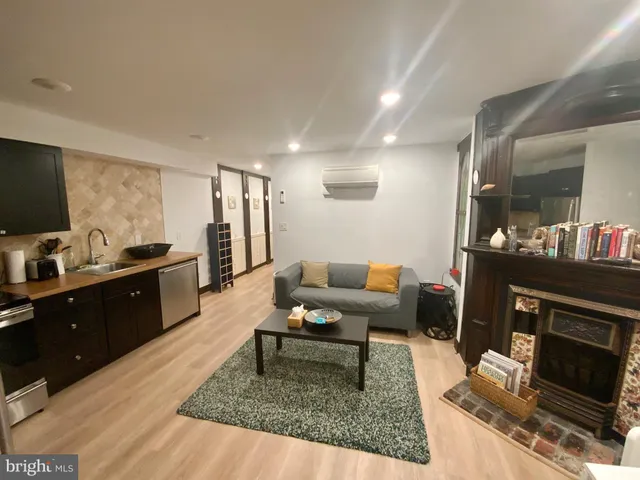 a living room with furniture and a fireplace