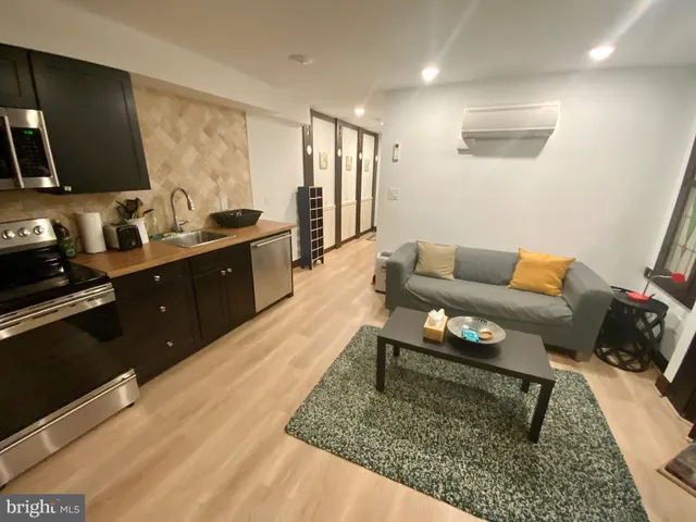 a living room with furniture and a rug