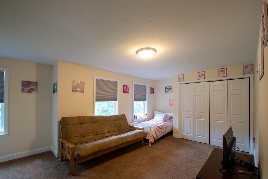 70 Frederick Street Fitchburg, MA 01420 - Photo 13 of 19 a bedroom with a bed and a couch