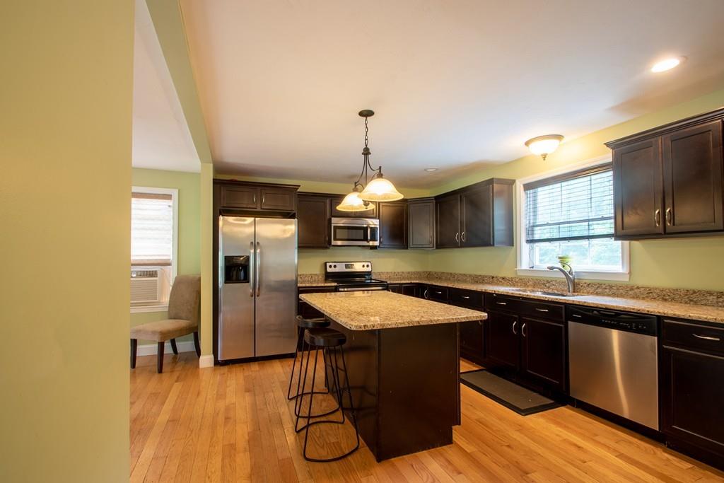 70 Frederick Street Fitchburg, MA 01420 - Photo 2 of 19 a kitchen with granite countertop a sink counter top space and stainless steel appliances