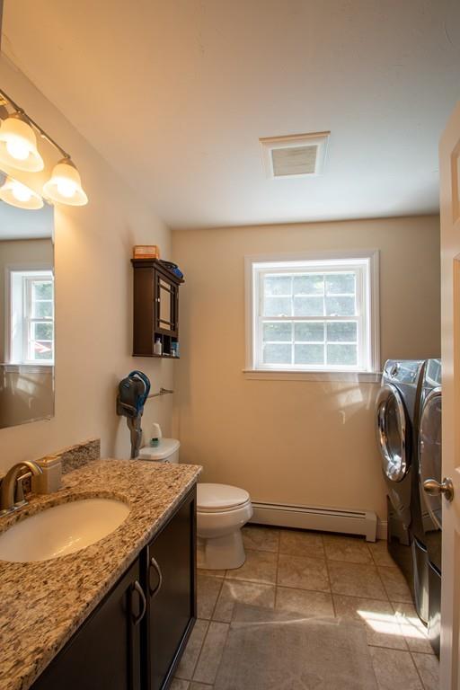 70 Frederick Street Fitchburg, MA 01420 - Photo 8 of 19 a bathroom with a granite countertop sink a toilet and mirror