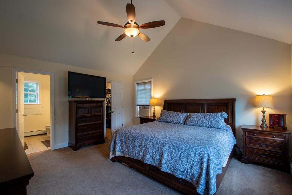 70 Frederick Street Fitchburg, MA 01420 - Photo 9 of 19 a bedroom with a bed and a chandelier