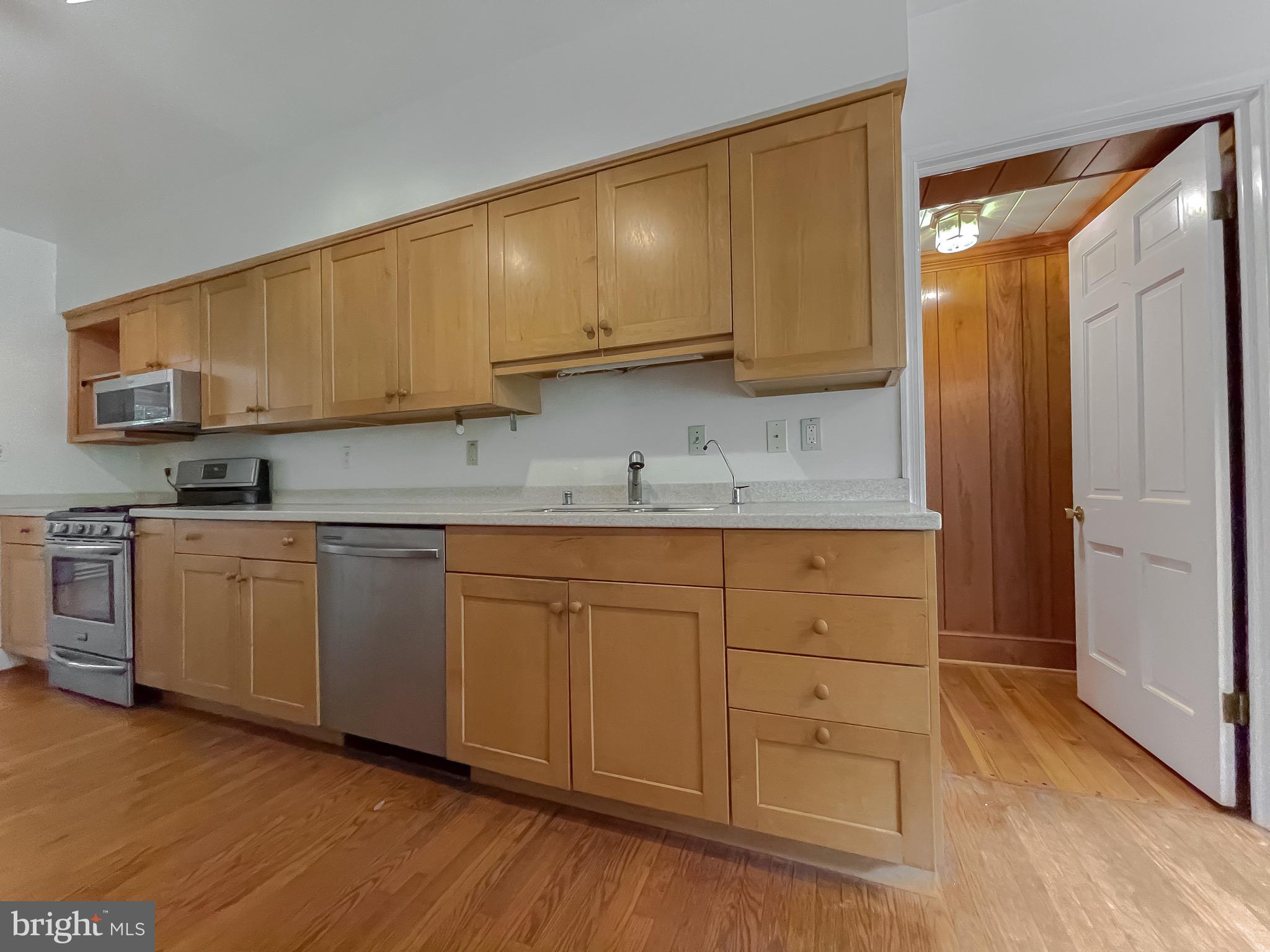 159 West Bay Front Road Lothian, MD 20711 - Photo 27 of 64 a kitchen with granite countertop cabinets and wooden floor
