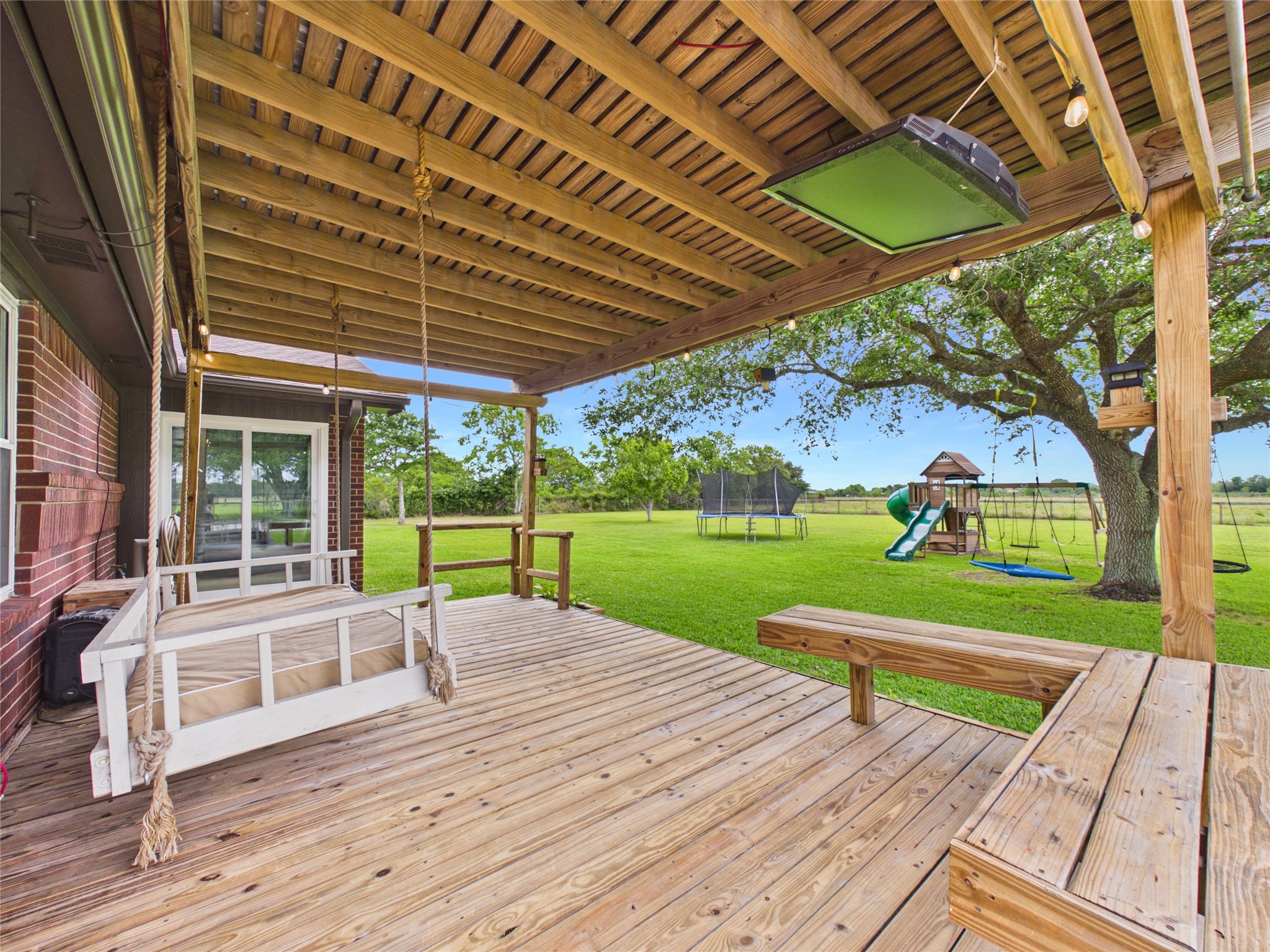 4610 Mustang Road Alvin, TX 77511 - Photo 41 of 50 Outdoor Patio #1 with large swing and great bench seating. Watch the sun rise/set from your new back yard!