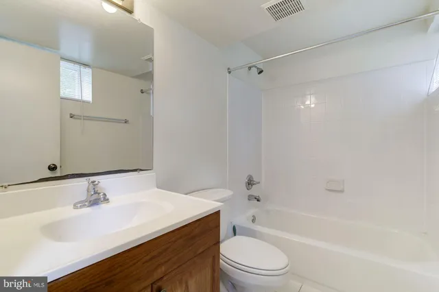 a bathroom with a sink toilet vanity and shower