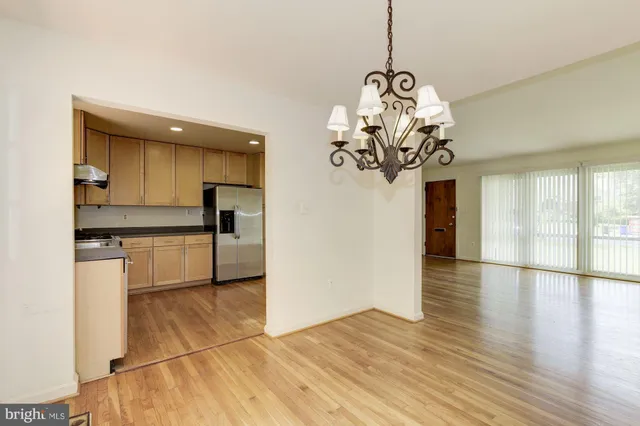 a view of a kitchen with a sink and refrigerator