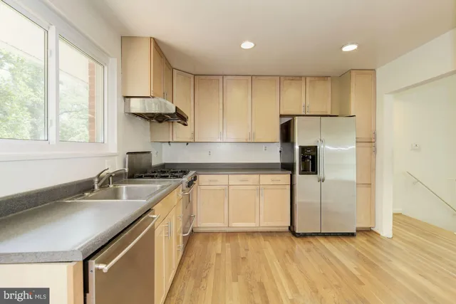 a kitchen with a sink a refrigerator and window