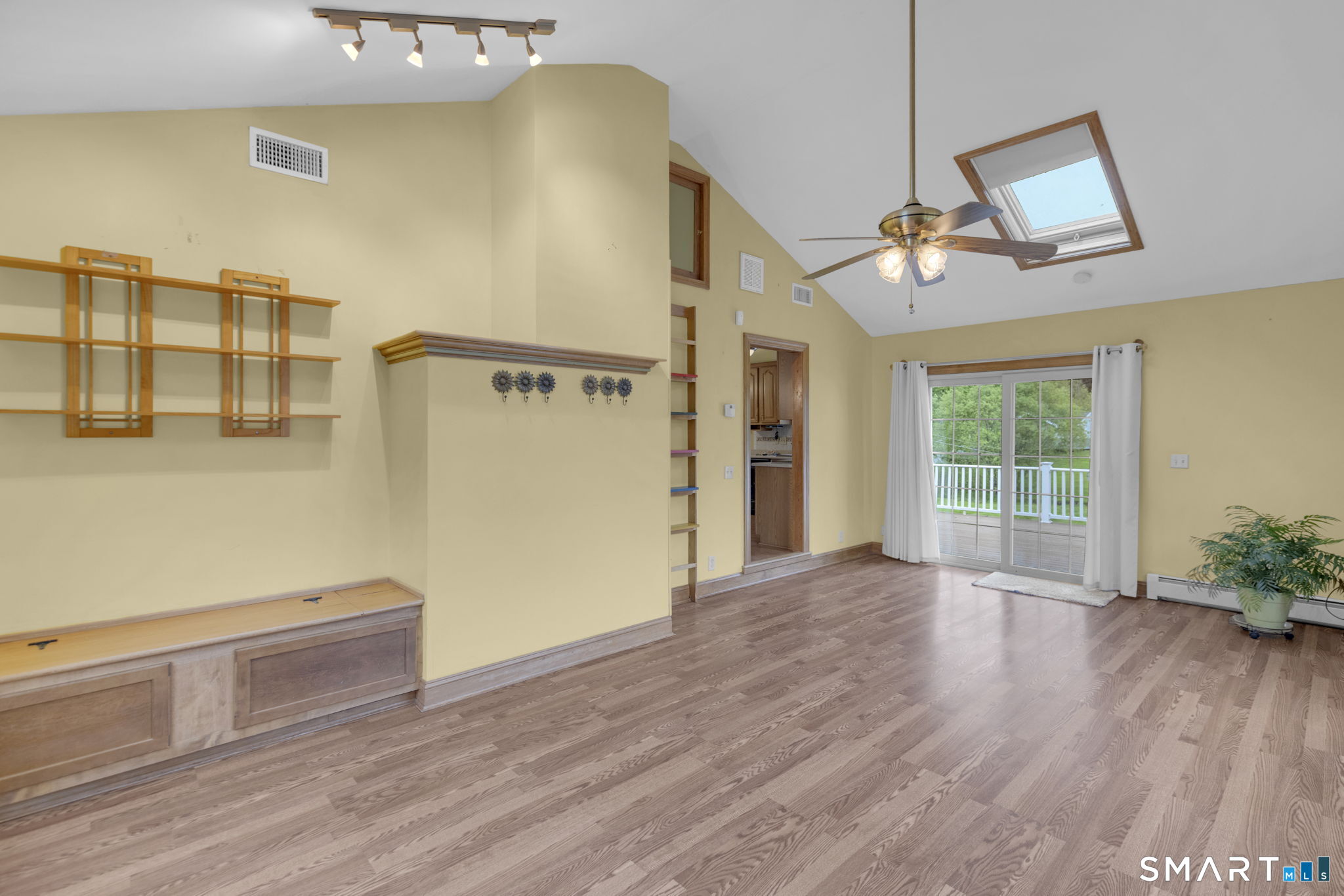 102 Wayne Lane Meriden, CT 06450 - Photo 27 of 36 a view of a livingroom with wooden floor and a ceiling fan