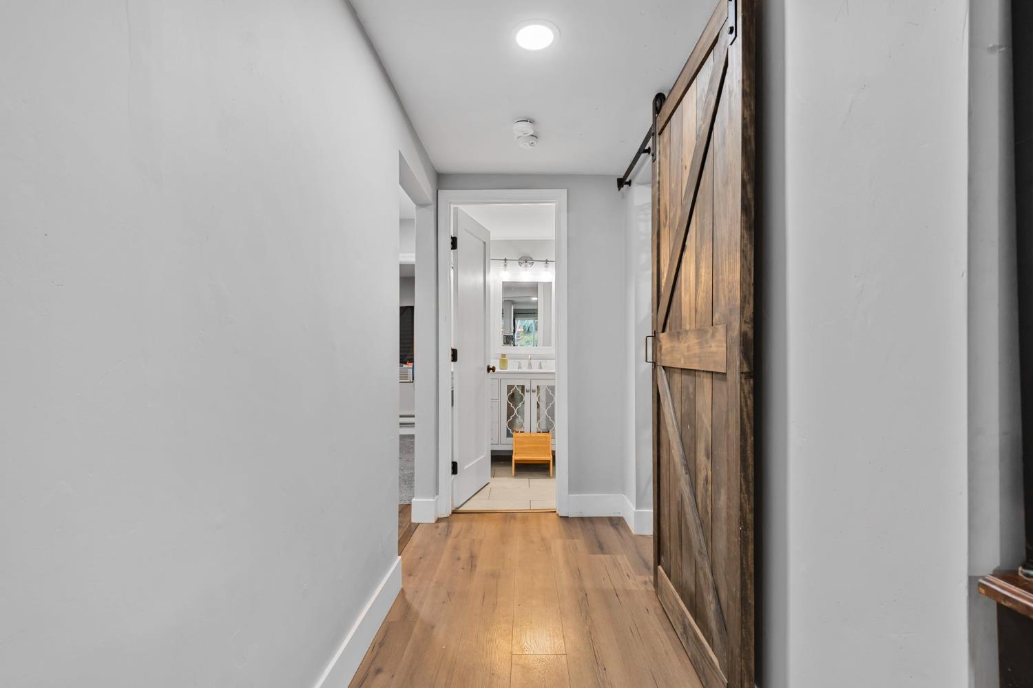 17721 Ridge Road Pine Grove, CA 95665 - Photo 5 of 21 a view of a hallway with wooden floor and staircase