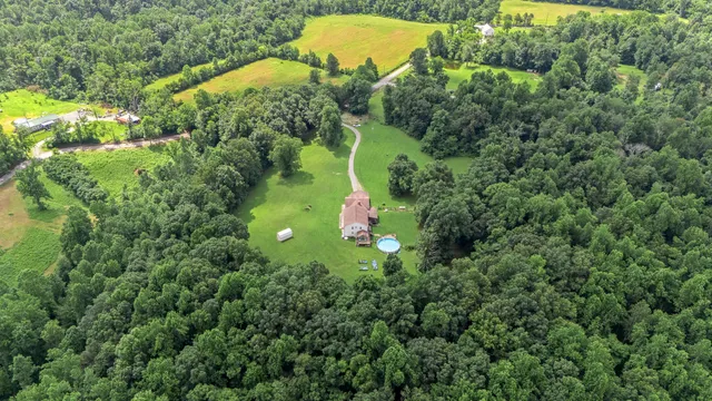 a view of a house with a yard and sitting area