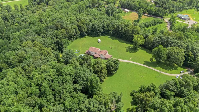 a view of a room with wooden floor and a ceiling fan