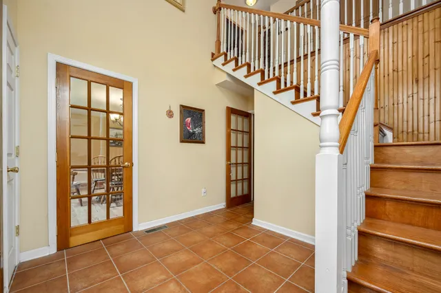 a bathroom with a granite countertop sink a mirror and a shower