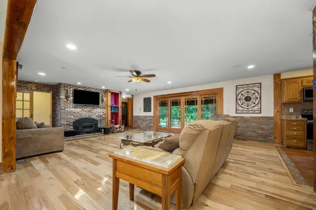 a view of a hallway with wooden floor and stairs