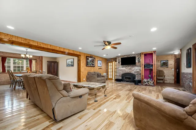 a view of a hallway with wooden floor and chandelier