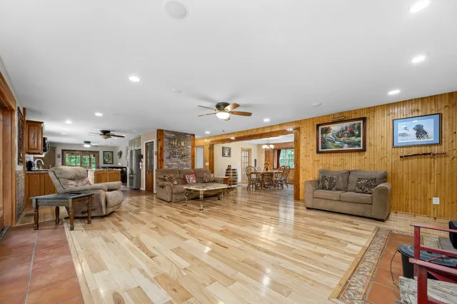 a living room with a bed furniture and a window