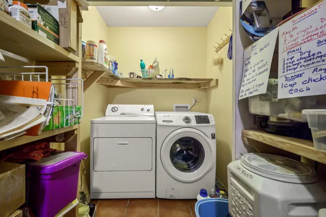 a bedroom with a bed and a large mirror with a dresser