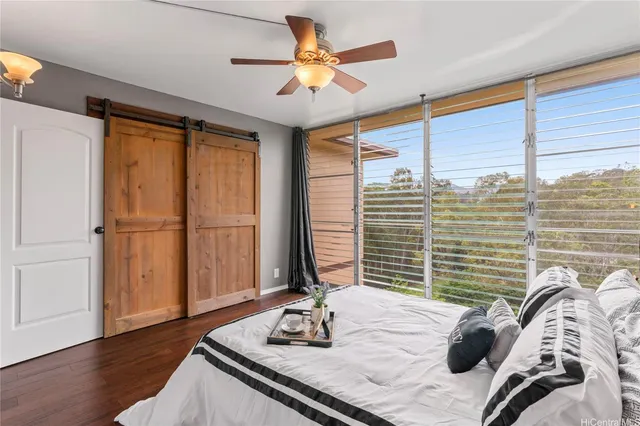 a bedroom with bed and a large window