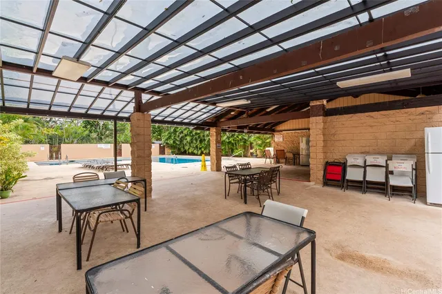 a view of a patio with table and chairs and potted plants