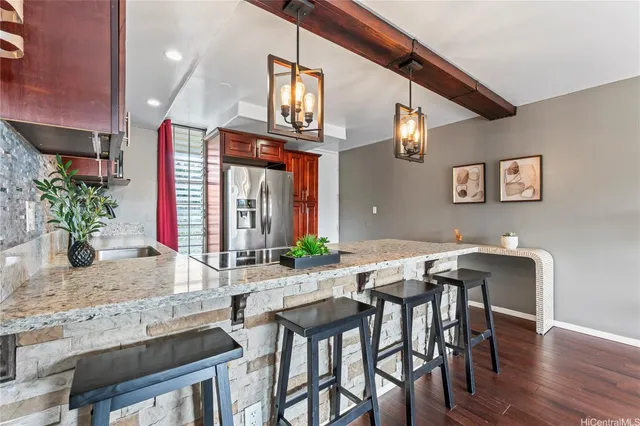 a view of a dining room with furniture and a potted plant