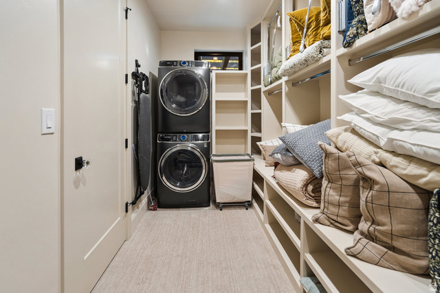 1141 South Oak Leaf Lane Springville, UT 84663 - Photo 106 of 147 Dedicated laundry area featuring stacked black appliances, integrated shelving, and light-colored carpet flooring