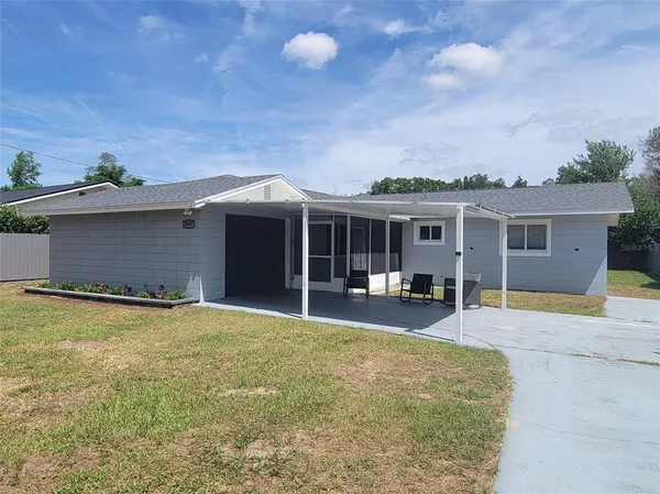a front view of house with yard and outdoor seating