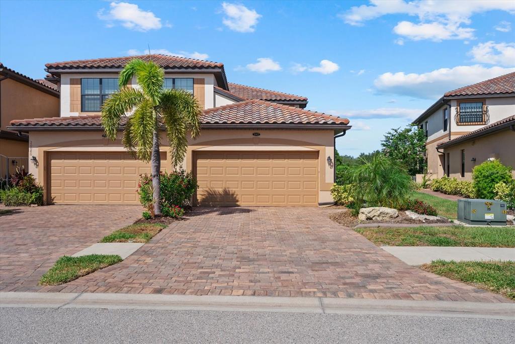20080 Ragazza Circle, Unit 102 Venice, FL 34293 - Photo 36 of 49 a front view of a house with garden