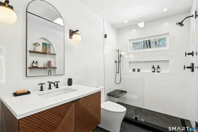 a bathroom with a sink toilet and shower