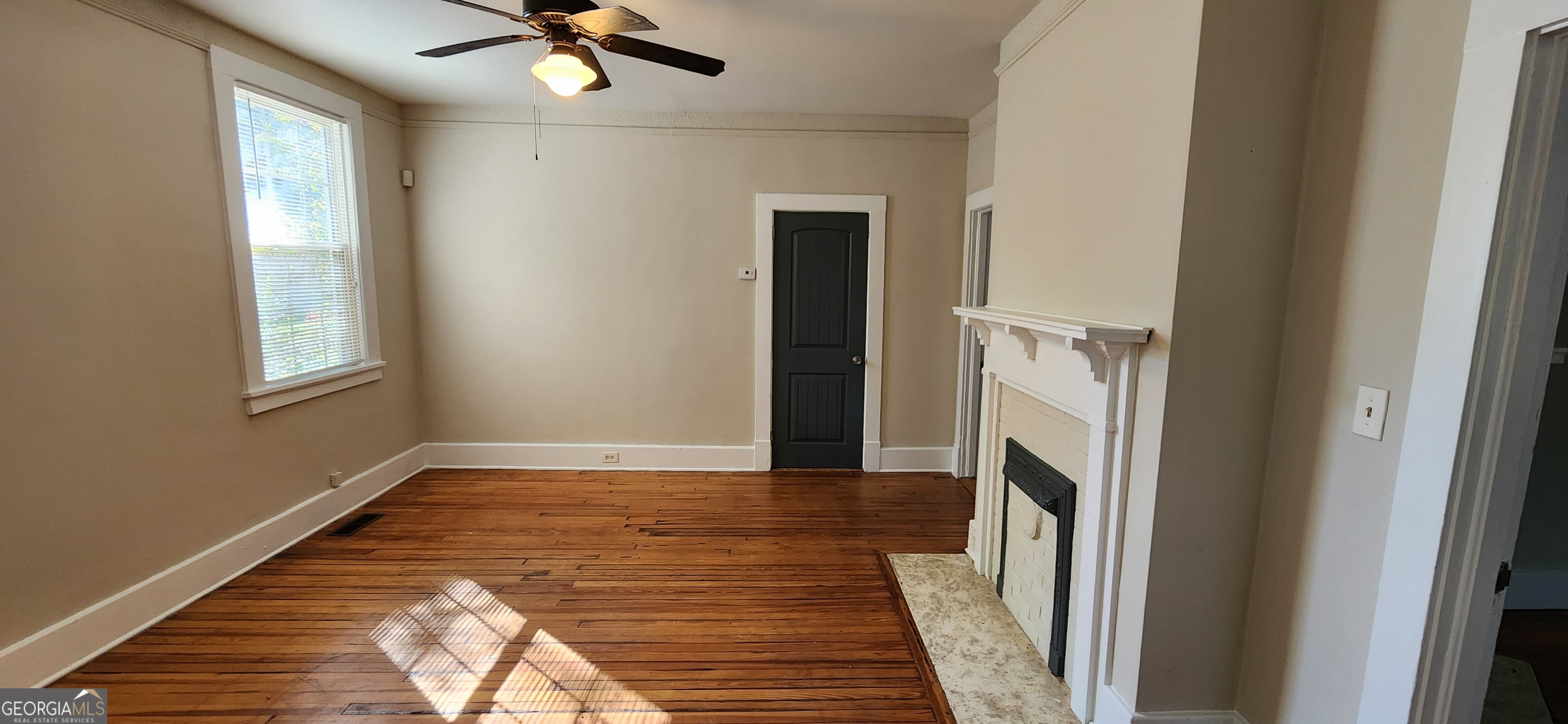 5120 A Newark Avenue Southwest Clarkdale, GA 30111 - Photo 5 of 11 a view of a livingroom with wooden floor and a ceiling fan
