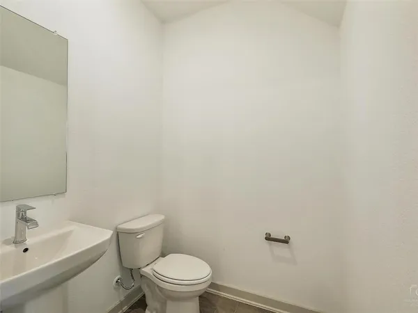 a white toilet sitting next to a bathroom sink